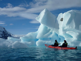 Kayaking through icebergs in Antarctica