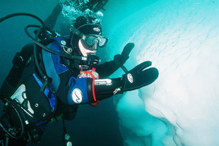 Charlotte Caffrey Diving next to iceberg
