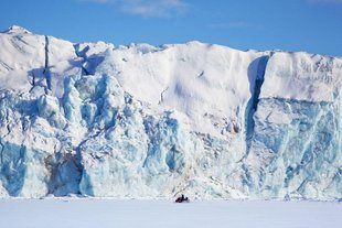 Snowmobiling past a glacier front, Spitsbergen