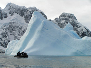 Diving zodiac by iceberg in Antarctica