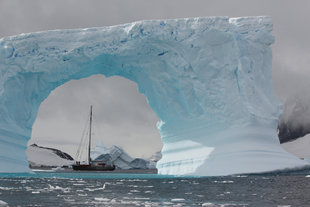 Arched Iceberg & Sailing Boat Antarctica