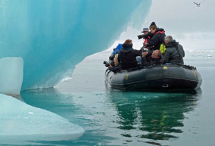 Zodiac cruising around an iceberg in Spitsbergen
