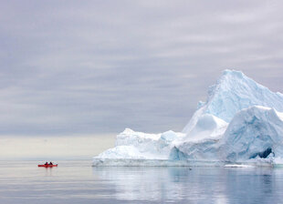 Kayaking by an Iceberg near Baffin Island