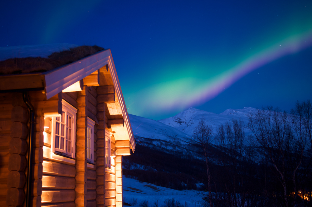 Northern Lights above lodge in Lyngen Alps Arctic Norway