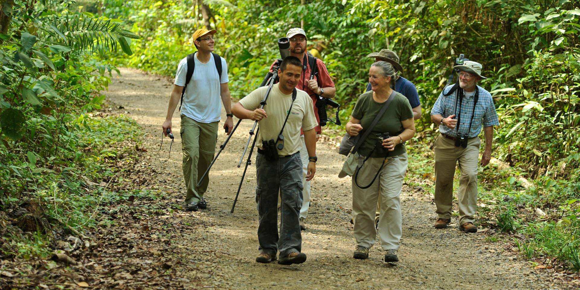A guided tour group walking along Panama's Pipeline Road